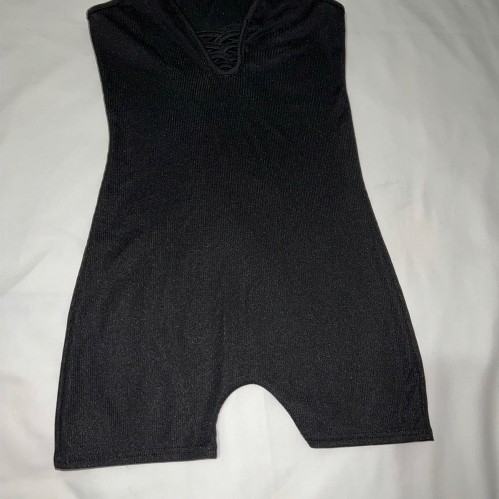 Black connected top and bottom, cleavage reveling